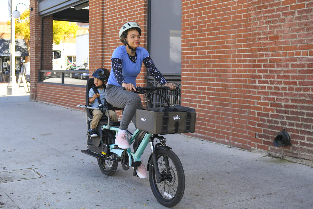 Yuba FastRack electric cargo bike with front basket and child seat