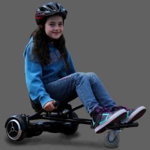 Riding a black GlideKart hoverboard seat attachment by Ride The Glide