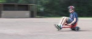 Red GlideKart on gravel, have lots of fun with Ride the Glide's hoverboard seat attachment